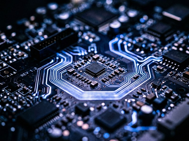 Macro circuit board with glowing blue traces